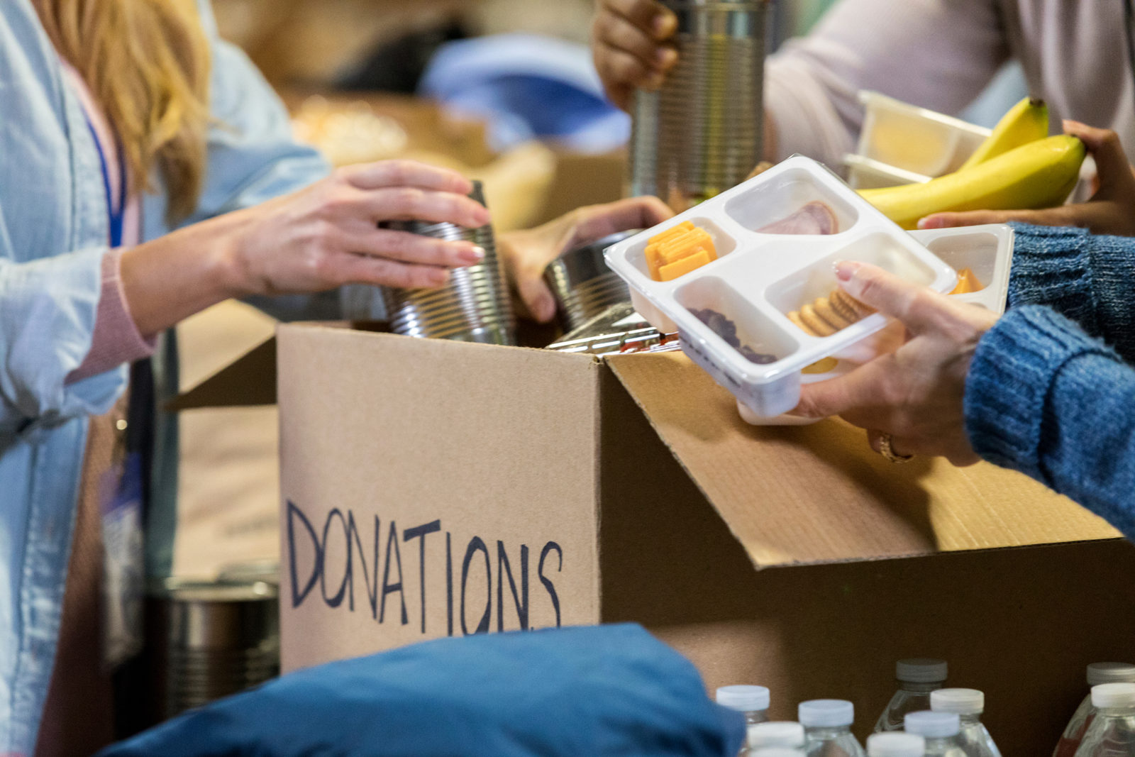 Food bank volunteers sort through donations during community food and clothing drive.